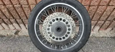 18x2.15" Front wheel off a 2005 vstar 1100. Includes rotors. Rim is straight no damage. Tire is shot...