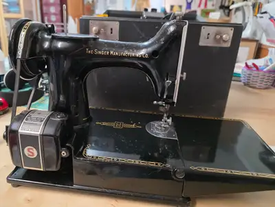 This Featherweight machine works well. It comes with the original wooden case, power cord, foot peda...