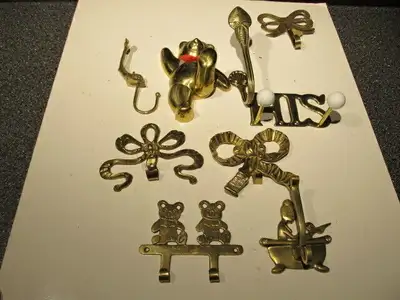 Assorted vintage brass wall hooks., View more
