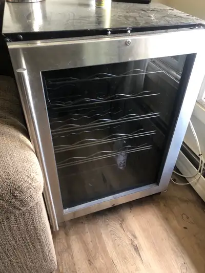 Holds 65-70 bottles. It does needs a repair ($100) as the refrigerant is not working- pick up at you...
