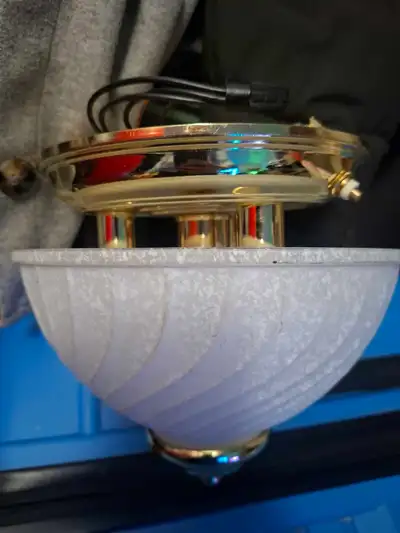 This is a used RV light fixture with a gold base and a swirled white glass shade, perfect for adding...