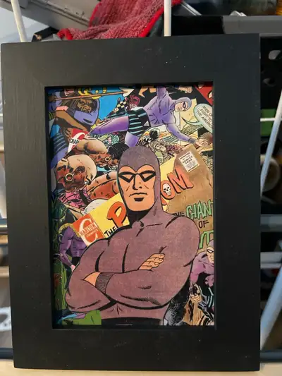 Add a vintage touch to your space with this framed Phantom comic art! This unique piece features a c...