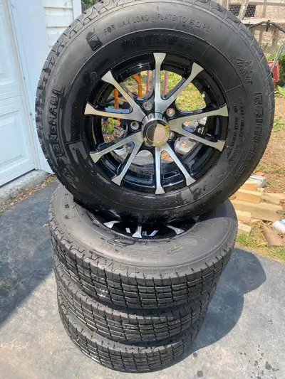 Brand new never installed or used 14” aluminum rims with tires,Center caps and wheel nuts . 2 sets t...