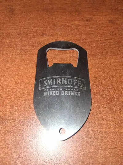 This is a used Smirnoff bottle opener, ready to pop open your favourite beverages! It's sturdy and s...