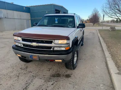 ‘02 Suburban, runs very well, 4” lift kit, 8 passenger third row seating. Good rubber, blows cold a/...