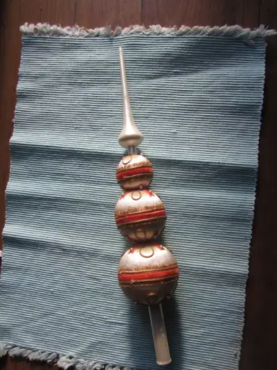 here we have a vintage tree topper with decorative yarn covering the form in red and gold with minia...