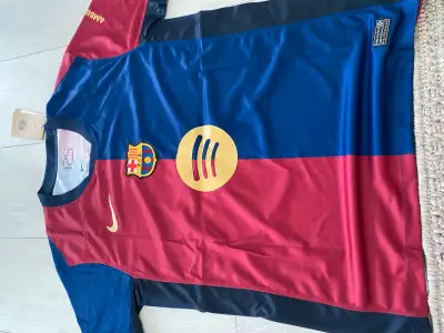 Selling a brand new Barcelona football jersey, featuring the iconic colours and design. This high-qu...