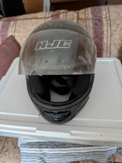 This is a black HJC full-face motorcycle helmet, size medium, in used condition. It's ready to offer...