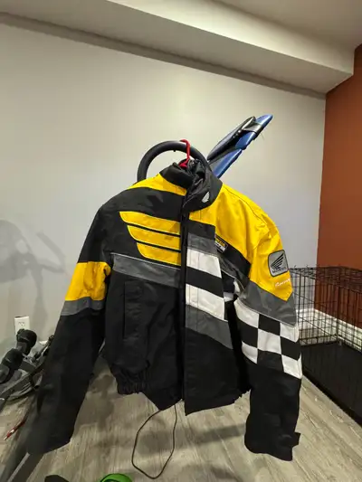 Bold and durable Honda motorcycle jacket featuring a yellow, black, and checkered design. Part of th...