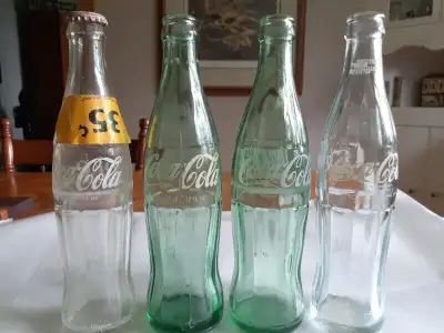 Four Glass Coke bottles, View more
