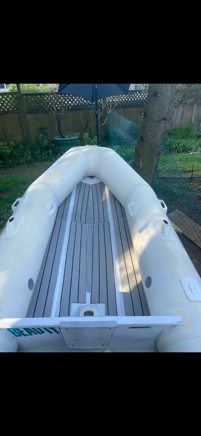 3 person Rib. Aluminum floor, inflatable portion holds air no leaks. Comes with oars rowing seat and...