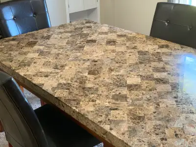 Beautiful marble table and 4 high-back chairs in excellent condition. Table measures 70” long, 42” w...