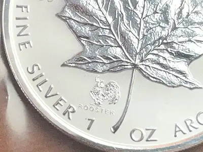 The addition of the privy mark on the 2005 1 oz Canadian Silver Maple Leaf Lunar Rooster Privy makes...