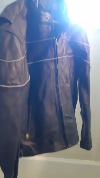 NEW leather motorcycle style leather coat never worn( tags still on) coat is a large but in my opini...