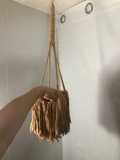 Tan Boho Macrame Plant Hanger. NEW 29” long Can fit a pot up to 7” Nice braid work. Brand New $20 Ca...