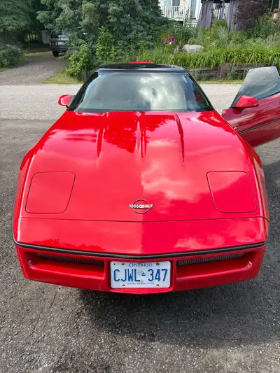 Selling my 1987 Chevrolet Corvette (C4) in classic red with a black roof. This is a timeless America...