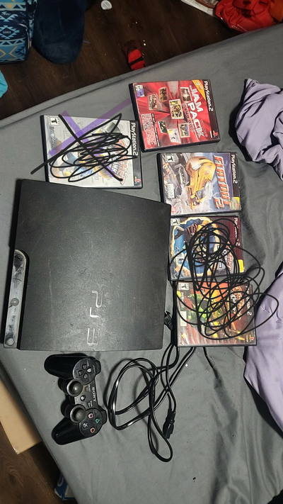 Ps3 with cords and one controller and two ps2 games, View more