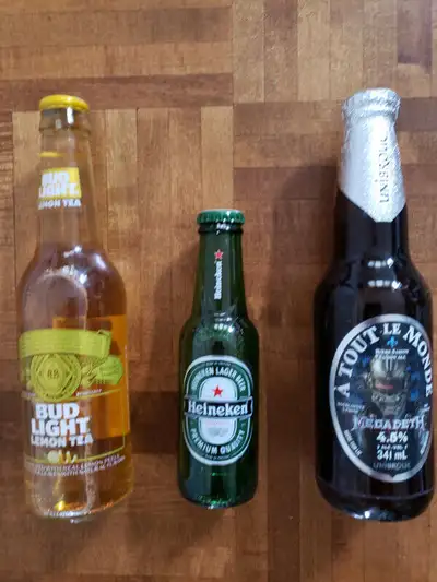 3 bottles; -- Budweiser light lemon tea, will grenade cap. -- Megadeth beer from Unibroue Montreal....