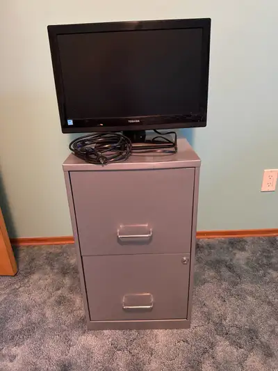 Filing cabinet and video monitor., View more