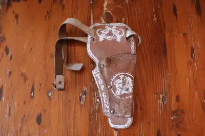 Hi. I have a vintage toy gun holster for sale. The holster shows some wear and marks. It is a single...