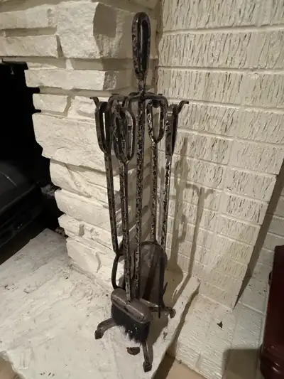 Keep your hearth tidy with this black iron fireplace tool set, complete with a stand, shovel, poker,...