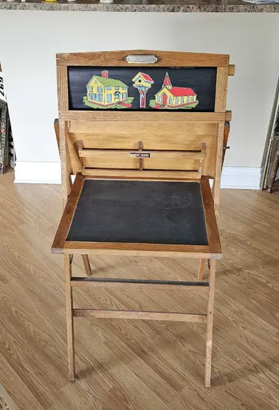 Terrific old children's easel desk with rolling paper images. Chalkboard is cracked right across and...