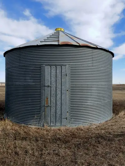 Four Westeel and Butler Grain Bins. 2,750 bushel bins on wood floors. Oversized doors suitable for s...