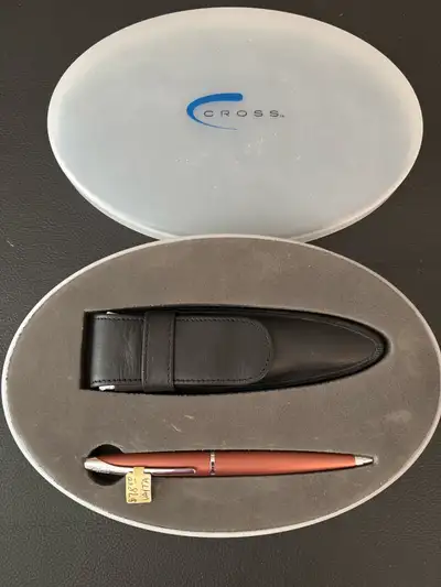 This CROSS ballpoint pen features a sleek design and comes with its original case and a leather pen...