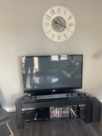 Entertainment stand, TV, sound bar and woofer for sale for sale 