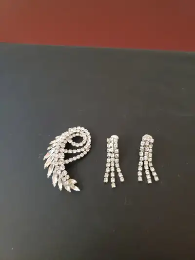 Vintage Sherman clear rhinestone brooch and matching clip earrings. All three pieces signed Sherman....