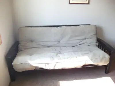 Futon for sale. It works just fine as a couch. As a bed, though, the mattress is a little mis-shapen...