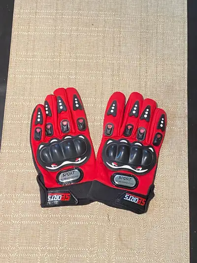These are a pair of Sport motorcycle gloves in used condition that offer both style and protection....