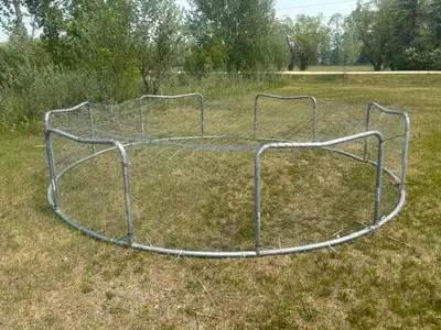 14' diameter trampoline frame repurposed into a chicken/duck tractor. Sides are covered in chicken w...