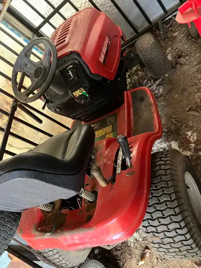 Two lawn tractors red one runs but belt slipping & crack in motor and a parts tractor to swap motors