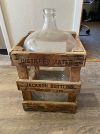 Antique crates and water cooler bottle