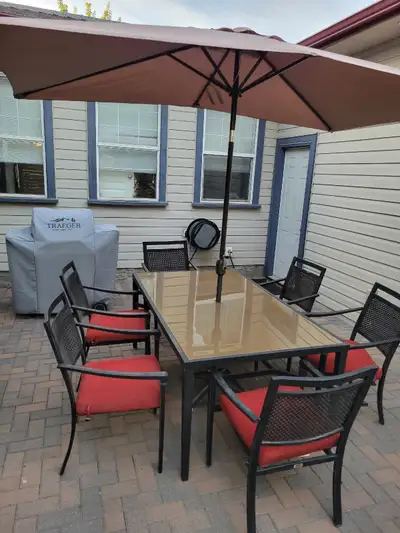 Aluminum outdoor table with 6 chairs and 2 year old umbrella.