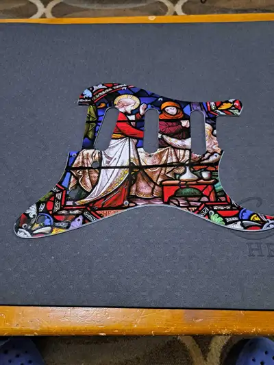 Brand new condition religious theme pickgaurd for a stratocaster guitar.
