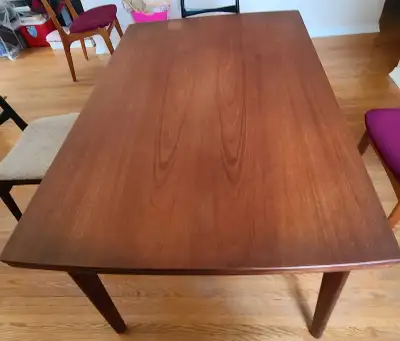Teak dining room table with 2 leaves built in under table. Seats 6-12 people. Made in Denmark by H.P...