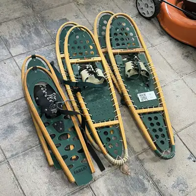 A group of green and wood-framed Faber Winter Leisure snowshoes with adjustable bindings and laced d...