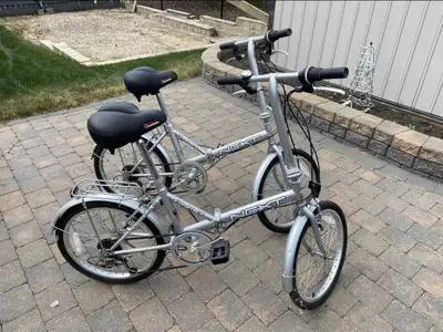 2 Like New NEXT Compact Folding Bicycles With Kickstands., View more