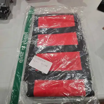 I'm selling a brand new motor bike seat cover in its original packaging. The cover features a striki...