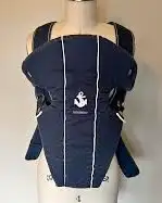 Ergonomic baby carrier made from soft padded fabric. Design supports baby and person. Baby can snugg...