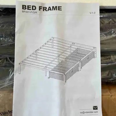 King size black metal bed frame with two large baskets on wheels. All pieces and hardware included i...