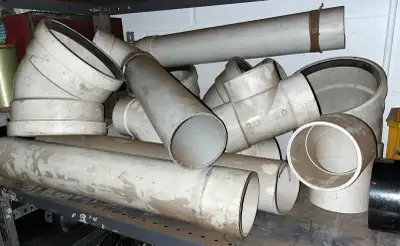 Assorted PVC pipes and fittings. Most are 4” diameter. 2’ straights x 4, multiple T’s and multiple 9...