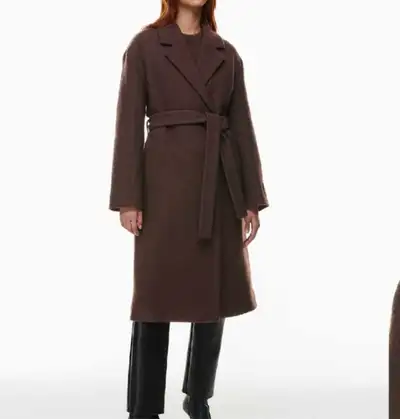 This coat still contains the tags. It has never been worn. The original price for this jacket was $3...
