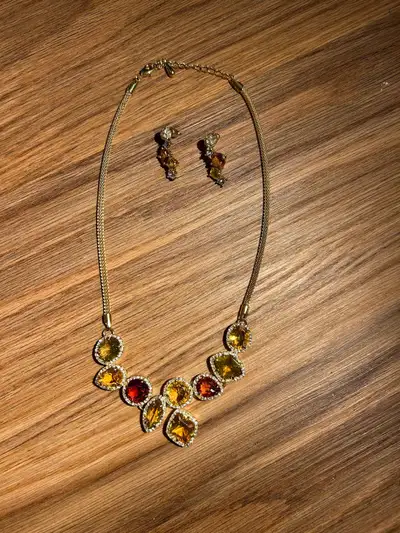 Elegant jewelry set includes a gold-tone mesh chain necklace and matching drop earrings. The necklac...