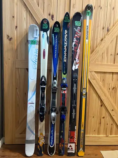 Assortment of downhill skis, boots, poles, helmets, goggles, bags, etc for sale. The ski lengths are...