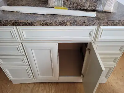 Beautiful custom built maple wood Vanity with arborite counter top and backsplash. White color .Appr...