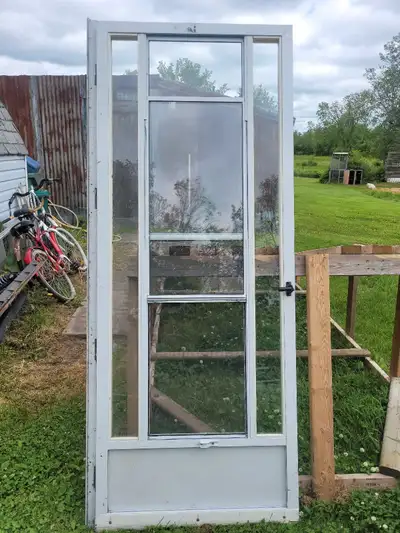Add a touch of charm to your space with this used screen door, measuring 32 inches by 79 inches! It'...