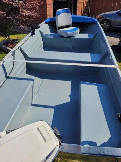 14 ft fiberglass boat, 9.9 Evinrude, Ez tilt trailer as well as trolling motor, battery, and fish fi...